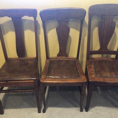 Closer view of other oak dining chairs. Chairs on far right needs repair.