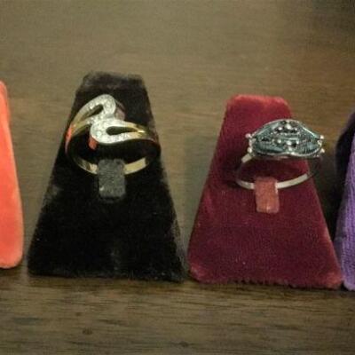Rings. First ring (orange background) signed Hollycraft.