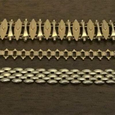 Three gold tone bracelets.  2 top bracelets are signed SARACOV. 3rd bracelet not signed.