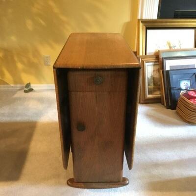 Opposite Sideview -  Storage compartment and drawer under drop leaf table.