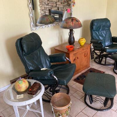 round iron table, pair of leather chairs and footstools