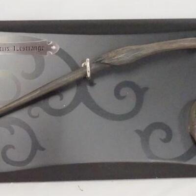 1094	HARRY POTTER THE NOBLE COLLECTION BELLATRIX LESTRANGE DEATH EATER WAND & MASK ON PLAQUE. 17 3/4 IN X 8 IN. 
