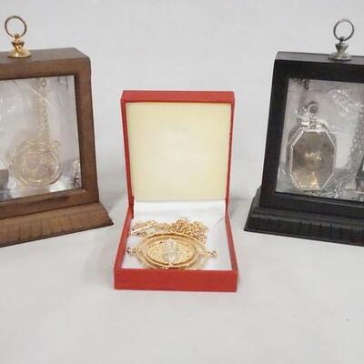 1074	LOT OF THREE HARRY POTTER NECKLACES, TWO COME IN NICE DISPLAY CASES. DISPLAY CASES ARE 4 3/4 IN X 3 3/4 IN, 1 3/4 IN DEEP. 
