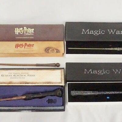 1181	LOT OF FOUR WANDS W/ BOXES. A HARRY POTTER THE EXHIBITION COMMEMORATIVE WAND, THE HARRY POTTER REMOTE CONTROL WAND & TWO MAGIC WANDS
