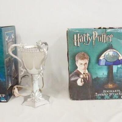 1173	LOT OF TWO NECA HARRY POTTER TABLE LAMPS W/ ORIGINAL BOXES. LOT INCLUDES THE TRIWIZARD CUP 12 IN H, & HOGWARTS TIFFANY STYLE LAMP...