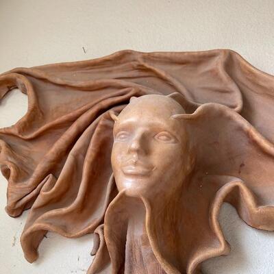 Leather carved ladies face 