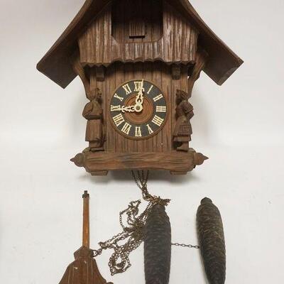 1245	CUCKOO CLOCK, SOMETHING MISSING ON HEADS OF THE 2 FIGURES, BODY OF CLOCK IS 16 1/4 IN HIGH
