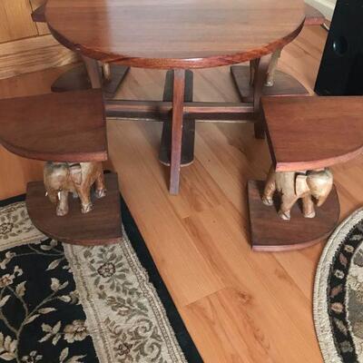 Small table with (4) elephant seats that fit inside table from Africa