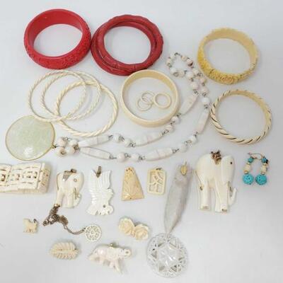 1652	

Costume Jewelry
Includes Bracelets, Pendants, Pins, A Necklace And A Pair of Earrings