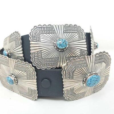 1396: Native American Sterling Silver Concho Belt with No. 8 Turquoise Stones By Artist June Defauto
Weighs Approx 467.1g
9 Conchos...