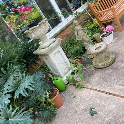 Pair cement planters on plinthes.