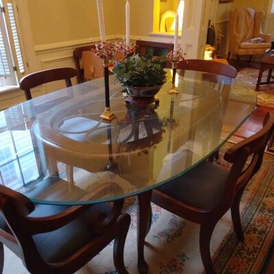 Oval glass top dining table and 8 chairs $1,100.00