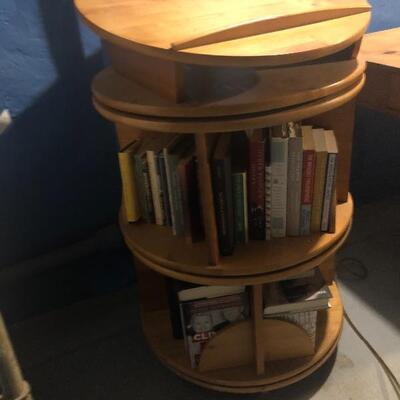 REVOLVING MAPLE BOOKSHELF FROM LEVINGER. 
IT SEPARATES INTO 3 PIECES WITH 2 REVOLVING SHELVES. 
IT MEASURES 24" IN DIAMETER AND THE...