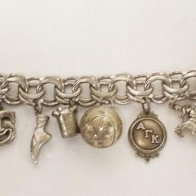 1168	STERLING SILVER CHARM BRACELET, FIST CHARM MARKED 800 WITH AN ANCHOR, MILK CAN AND MEDALLION MARKED STERLING, 8 OTHER CHARMS NO...