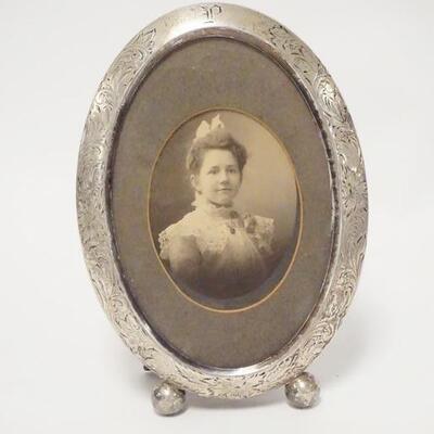 1031	STERLING SILVER PICTURE FRAME, HAS ENGRAVED DESIGN & OLD PHOTO, 7 IN X 5 IN
