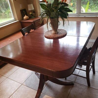 Cherry finish wooden dining room table, there are no chairs