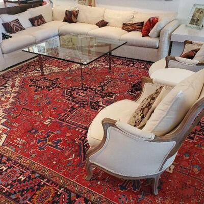 Persian hand knotted Heriz carpet, Mies van der Rohe style Barcelona table, mid-century sectional 