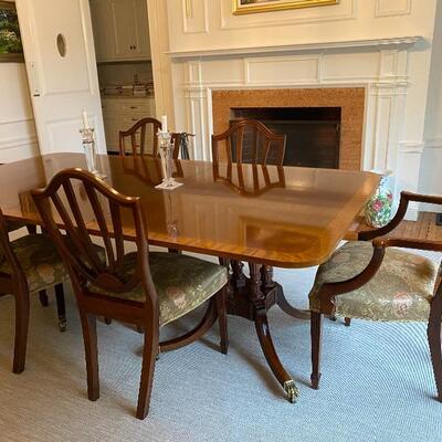 Baker Furniture Inlaid, double pedestal table with brass claw feet and castors. 6 Chairs.
