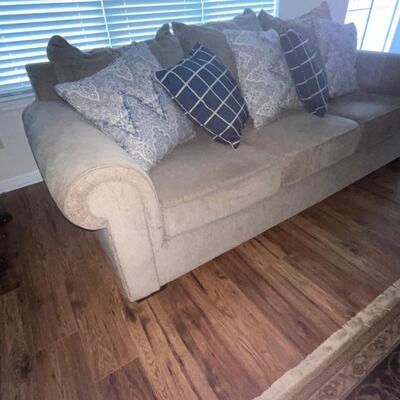 plush taupe sofa and throw pillows (not a sofa bed) (matching chair separate)