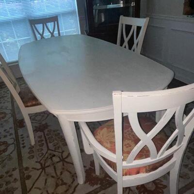 wood dining room table with extension leaf with 4 chairs, including 1 captain's chair