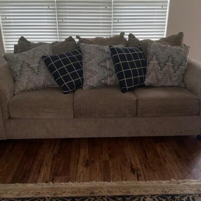 plush taupe sofa and throw pillows (not a sofa bed) (matching chair separate)