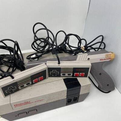 Original Nintendo System with two original controllers and the gun. Additional pad controller is also included, along with 11 games.