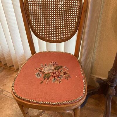 Embroidered, cane-back chair