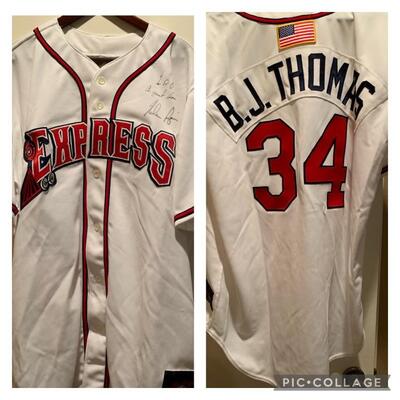 Signed / Autographed By Nolan Ryan, BJ  Thomas
Jersey presents to him and work we he threw out the first pitch at the Round Rock Express...