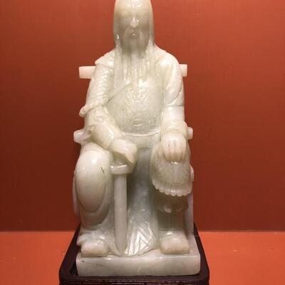 Chinese Carved White Jade Statue on Stand
Sits on a carved rosewood stand
11.5in t x 5in w at base
 Approximately 8 lbs��