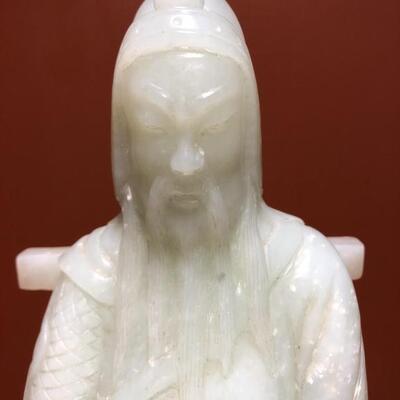 Chinese Carved White Jade Statue on Stand
Sits on a carved rosewood stand
11.5in t x 5in w at base
 Approximately 8 lbs