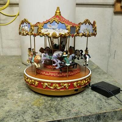 Carousel plays Christmas tunes or other tunes year round.  Battery operated. Cute!