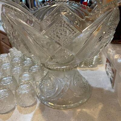 Gorgeous early 1900s pressed glass punch bowl set designed by McKee. Set includes a punch bowl and 24 cups with a pattern of circles 