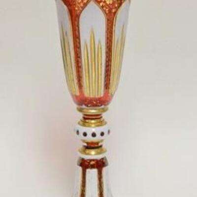 1009	BOHEMIAN WHITE CUT TO CRANBERRY TRUMPET VASE W/ GOLD ENAMELING & CUT SCULPTED TOP. 12 1/4 IN H 
