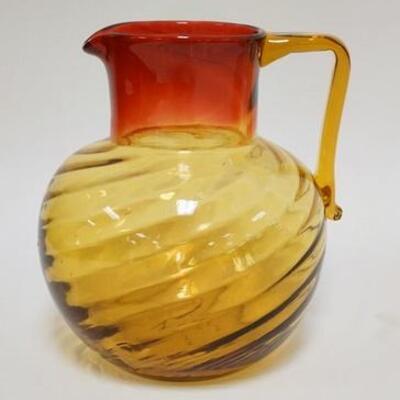 1004	ANTIQUE AMBERINA SWIRL PITCHER W/ APPLIED AMBER HANDLE & POLISHED PONTIL. 7 1/2 IN H 
