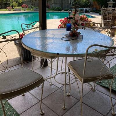 Vintage iron patio set with glass topped table