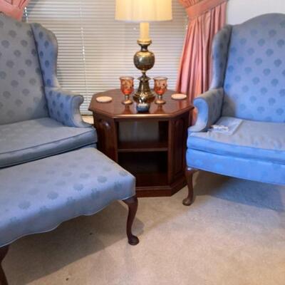 Blue wing-back chairs and ottoman