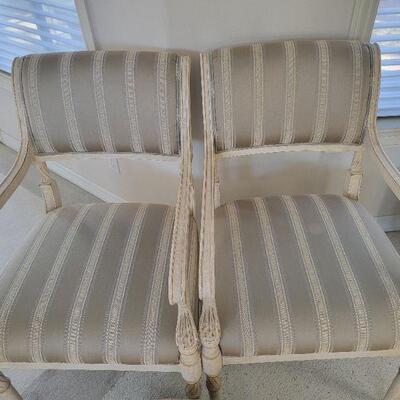 Two upholstered chairs with carved detail  