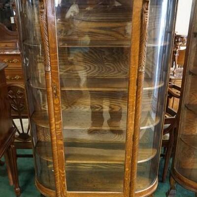 1045	CURVED GLASS OAK CHINA CABINET W/LION HEADS & CLAW FEET, 38 1/2 IN WIDE X 65 1/2 IN HIGH X 15 IN DEEP
