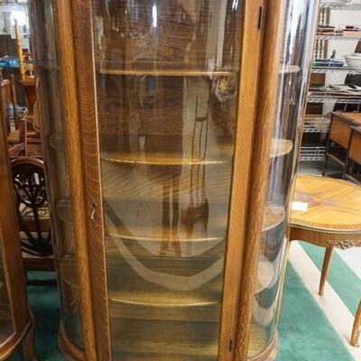 1046	CURVED GLASS OAK CHINA CABINET W/CLAW FEET, DOOR ALSO HAS CURVED GLASS, CORINTIAN HALF COLUMNS, 37 IN WIDE X 65 IN HIGH X 15 1/2 IN...