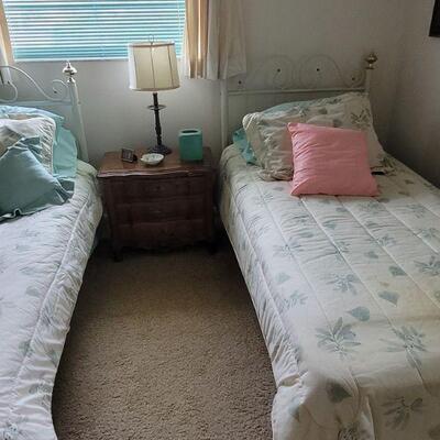pair of twin beds with metal headboards