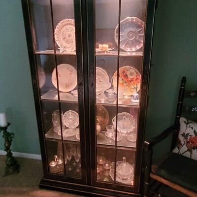 Very nice curio cabinet with glass shelves and it  is lighted