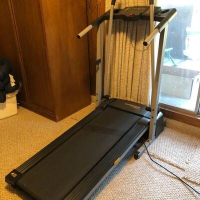 Treadmill - lightly used - folds up against the wall, on wheels.