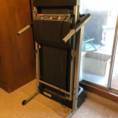 Treadmill - lightly used - folds up against the wall, on wheels.