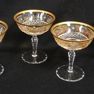 1037	4 FINE CUT CHAMPAGNES W/ A LIGHT IRIDESCENT STAIN & GOLD RIMS, STEMS & FEET ARE CUT, 4 5/8 IN HIGH

