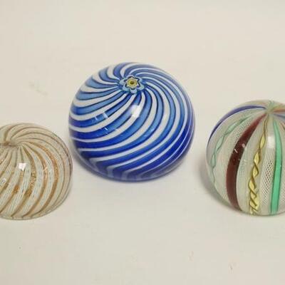 1099	3 INTERNAL SWIRL PAPERWEIGHTS, 2 HAVE LATTICINO CANES, SMALLEST IS SIGNED BUT NOT LEGIBLE, ALL HAVE POLISHED BASES, LARGEST IS 3 3/4...