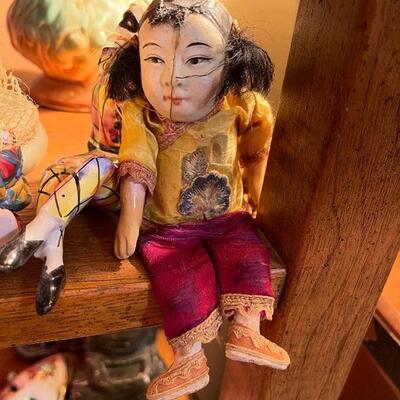 Antique composition doll in silk embroidered clothes