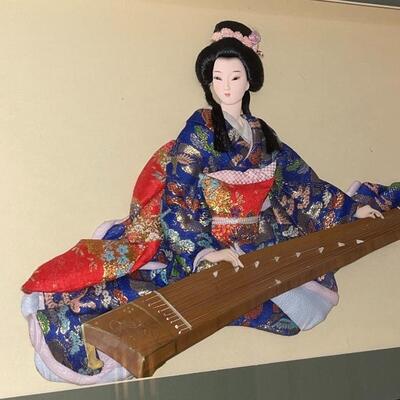 Japanese woman in Kimono playing the Koto.