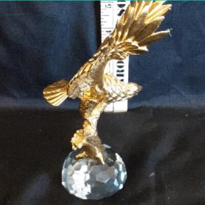gold colored metal eagle on a cut glass base