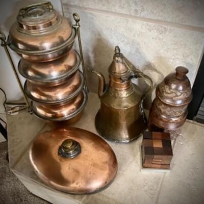 Many brass and copper bells, buckets, containers from Middle East and Europe. At left is copper â€œlunchboxâ€ from Greece.