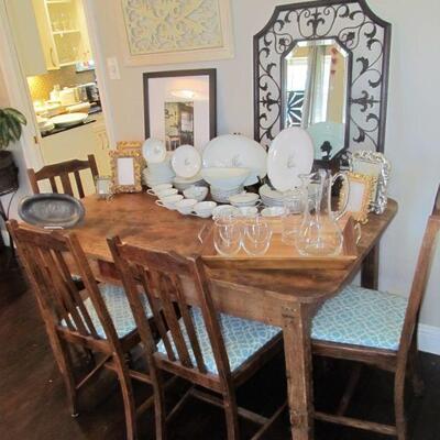 Antique reclaimed barnwood handmade dining table & antique chairs.  Wrought-iron decor & beveled mirrors. Southern living pitcher...
